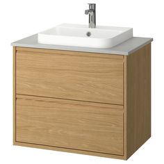 a bathroom sink sitting on top of a wooden cabinet next to a faucet