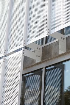 the side of an office building with perfored metal screens