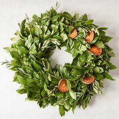 a wreath made out of leaves and oranges