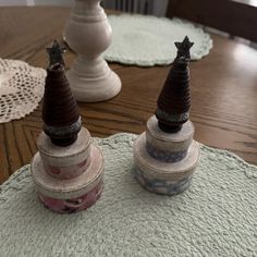 two small pots sitting on top of a wooden table