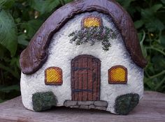 two pictures of a small house made out of clay