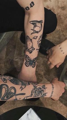 two people with tattoos on their arms and legs