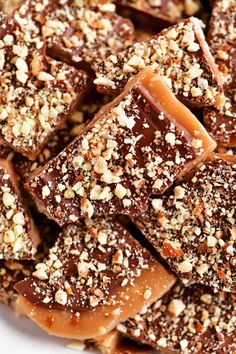 there are many pieces of chocolate and nuts on this plate, including toffes