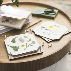 the table is covered with various cards and pens, including one that has flowers on it