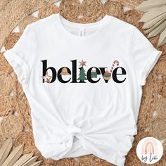 a white t - shirt with the word believe on it