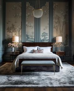 a bed sitting in a bedroom on top of a wooden floor next to two lamps