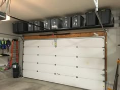 a garage with several storage bins on the ceiling