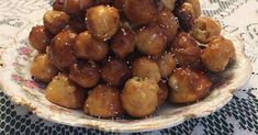 a bowl filled with fried food sitting on top of a doily covered tablecloth