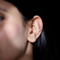 a close up of a person's ear with an earring