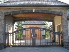 a gated entrance to a house with a clock on it