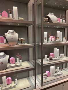 a display case filled with lots of white and pink items