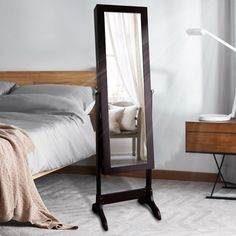 a bedroom scene with focus on the floor mirror