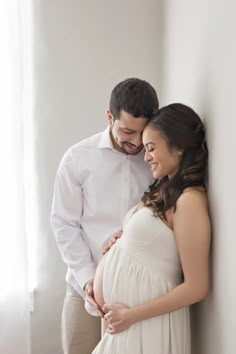 a pregnant couple standing next to each other