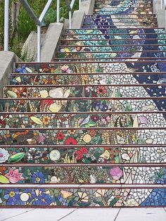 the stairs are decorated with colorful tiles and flowers