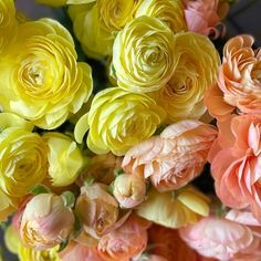 a bunch of yellow and pink flowers sitting on top of each other