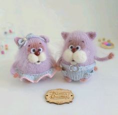 two small stuffed animals wearing sweaters and socks