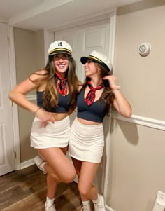 two women dressed in sailor outfits posing for the camera