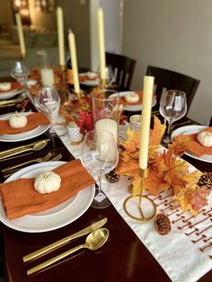 the table is set for thanksgiving dinner with candles