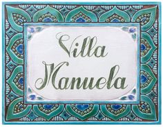 an ornate tile with the words villa manuela in green, blue and white colors