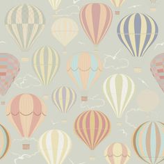 many hot air balloons flying in the sky with clouds and clouds behind them, on a blue