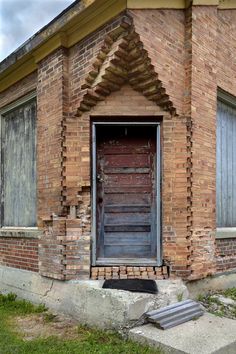 an old brick building with a wooden door