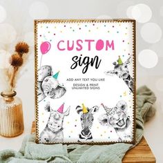 an animal themed birthday sign sitting on top of a table