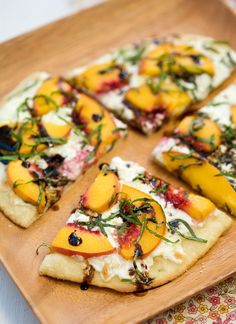 slices of fruit pizza on a wooden plate