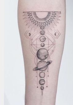 a woman's leg with an image of the sun and planets on it, in black ink