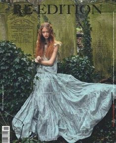 a magazine cover with a woman in a blue dress standing next to some ivy covered graves