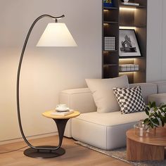 a living room with a couch, lamp and coffee table in front of the bookshelf