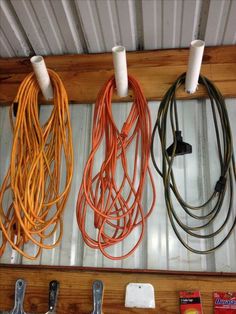 several different colored cords hanging on a wall