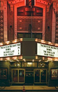 an old theater with marquee and neon lights