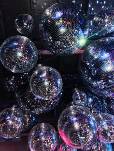 many shiny disco balls are stacked on top of each other