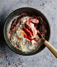 a bowl of oatmeal with fruit and chia seeds on the side