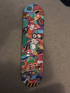 a colorful skateboard is laying on the ground