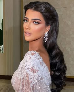 a woman with long hair wearing a white dress