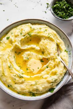 a bowl filled with mashed potatoes topped with an egg