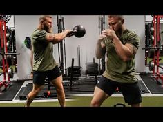 two men doing kettlebell exercises in a gym