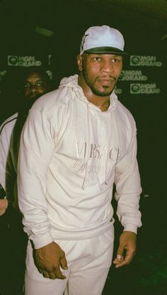 a man wearing a white hoodie and cap