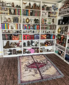 a room filled with lots of books and stuffed animals on top of white shelving units