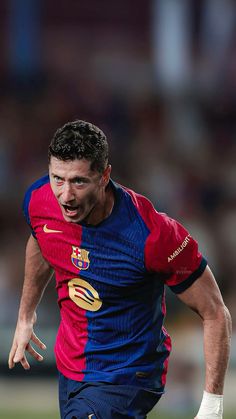 a man running with a soccer ball in his hand and wearing a red, blue and yellow uniform