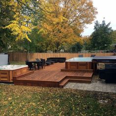 a deck with hot tubs and grill in the back yard