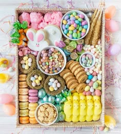 a tray filled with lots of different types of food and candy on top of a table