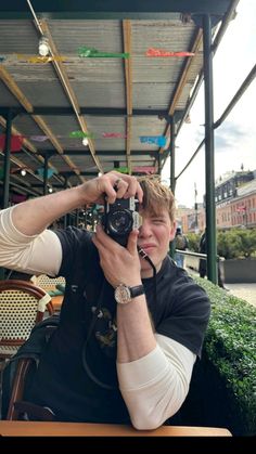 a man sitting at a table with a camera