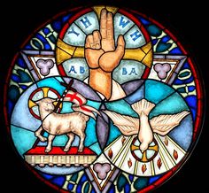 a stained glass window with an image of a hand and sheep