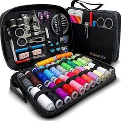 an open case filled with lots of different colored spools and sewing supplies in it