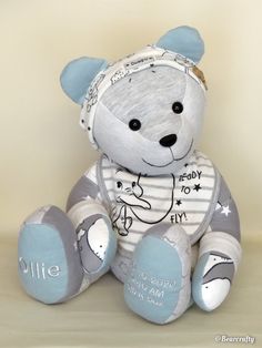 a teddy bear wearing a bib with writing on it