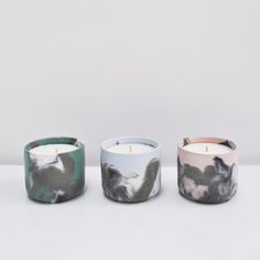 three candles sitting next to each other on a table