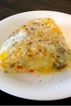 an omelet on a white plate sitting on a table