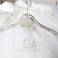 a white wedding dress hanging on a hanger